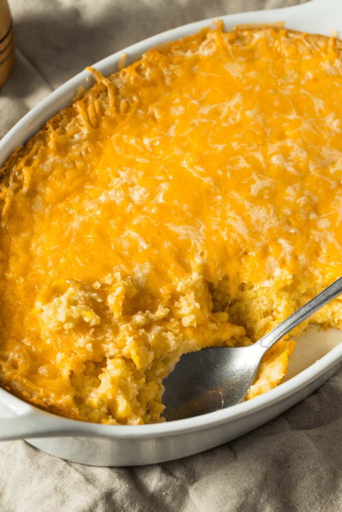 Corn casserole on a baking dish with spoon. 