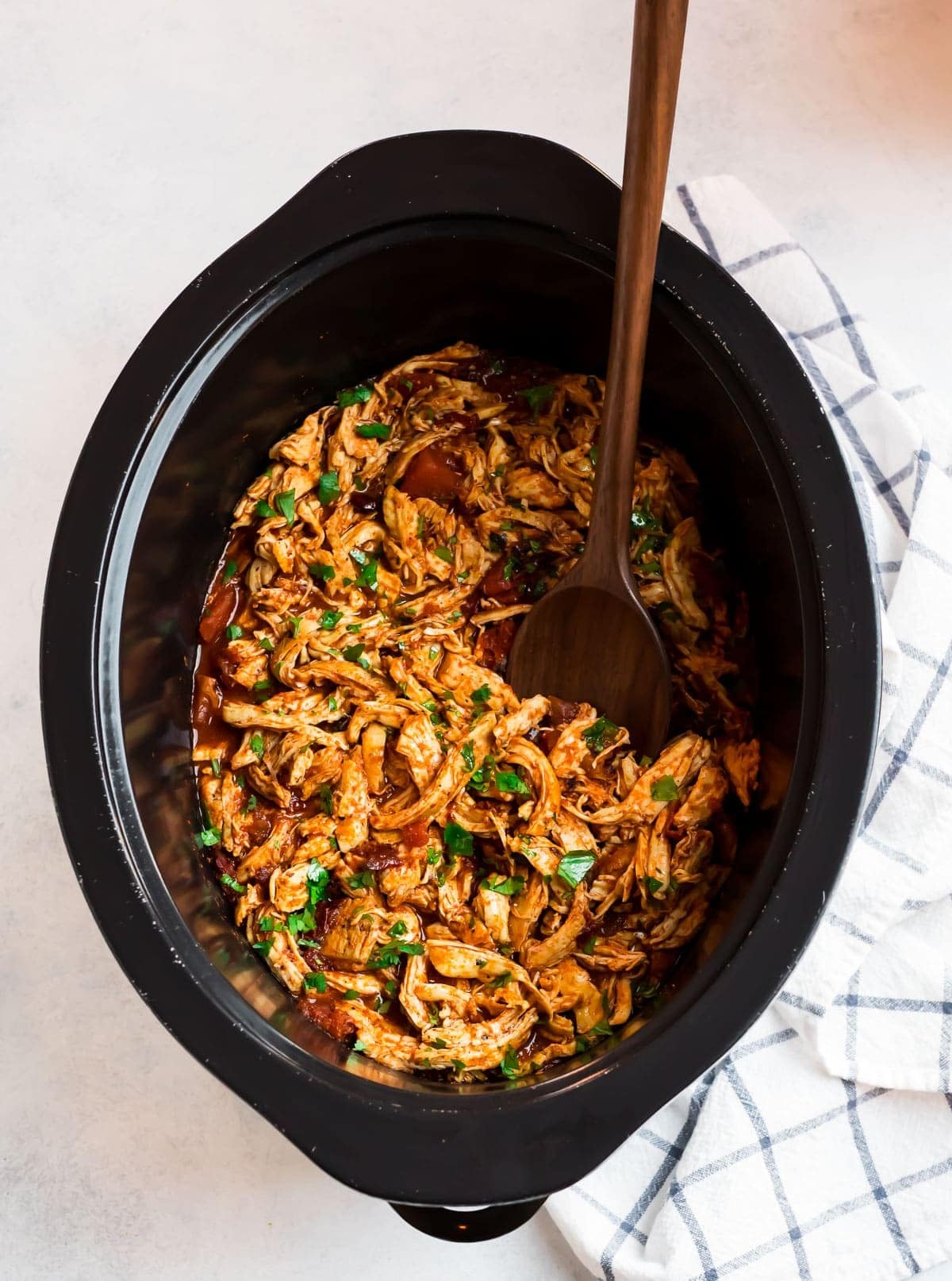 Wooden ladle dipped on a Crockpot Mexican Chicken Tacos