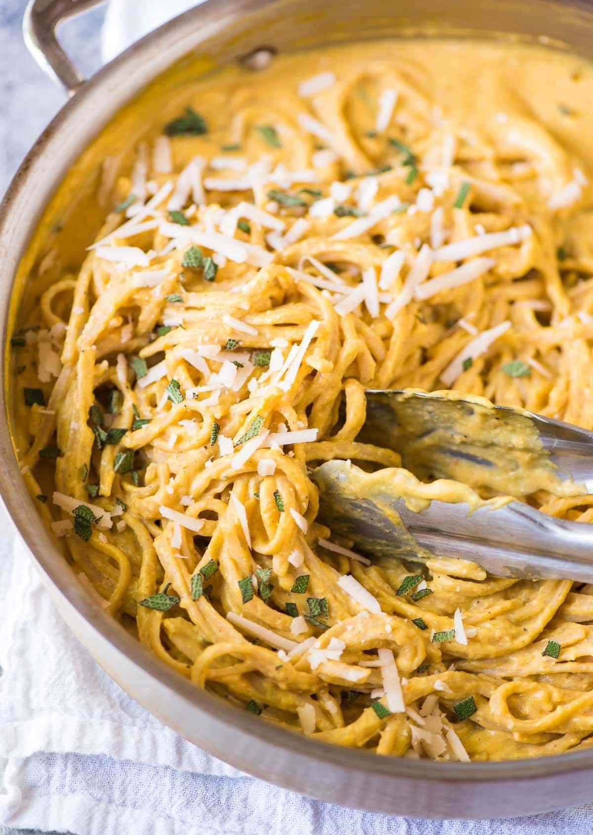 Pasta with pumpkin sauce mixed on a pan. 