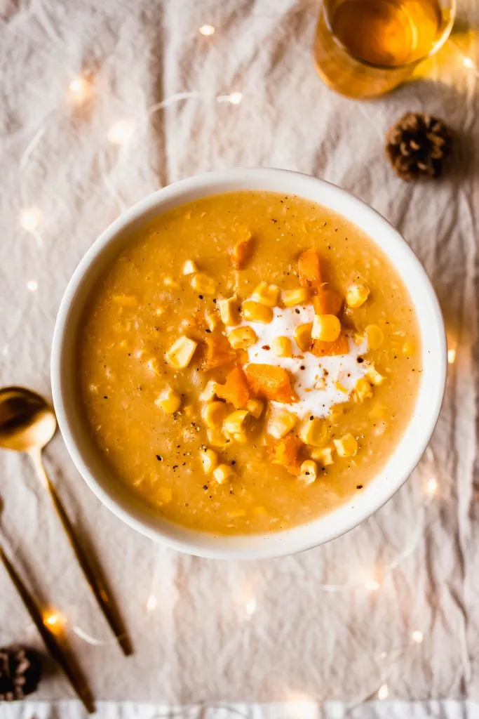 Pumpkin corn chowder on a bowl with cream. 