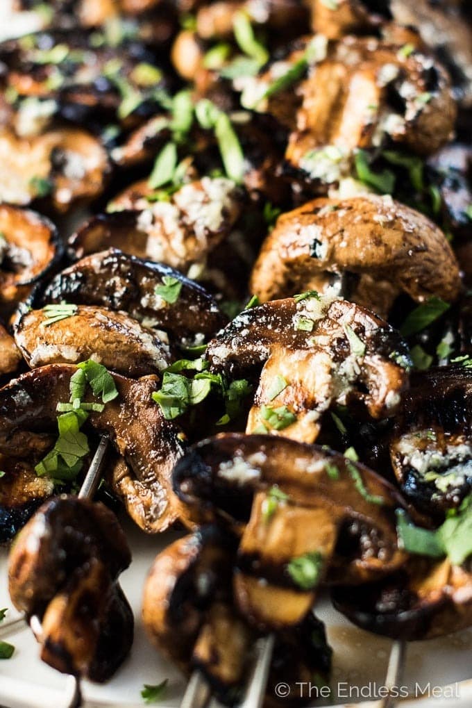 Grilled garlic butter mushrooms on skewers. 