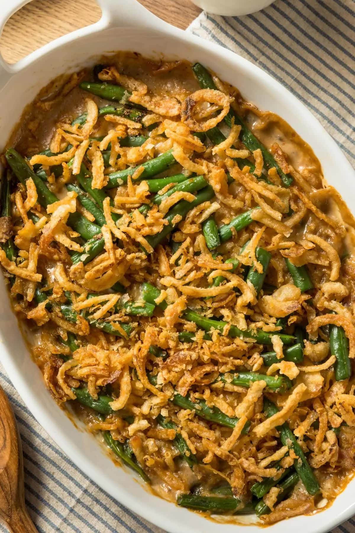 Green bean casserole garnished with fried onions. 