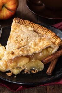 Homemade Apple Pie with Cinnamon in a Black Plate