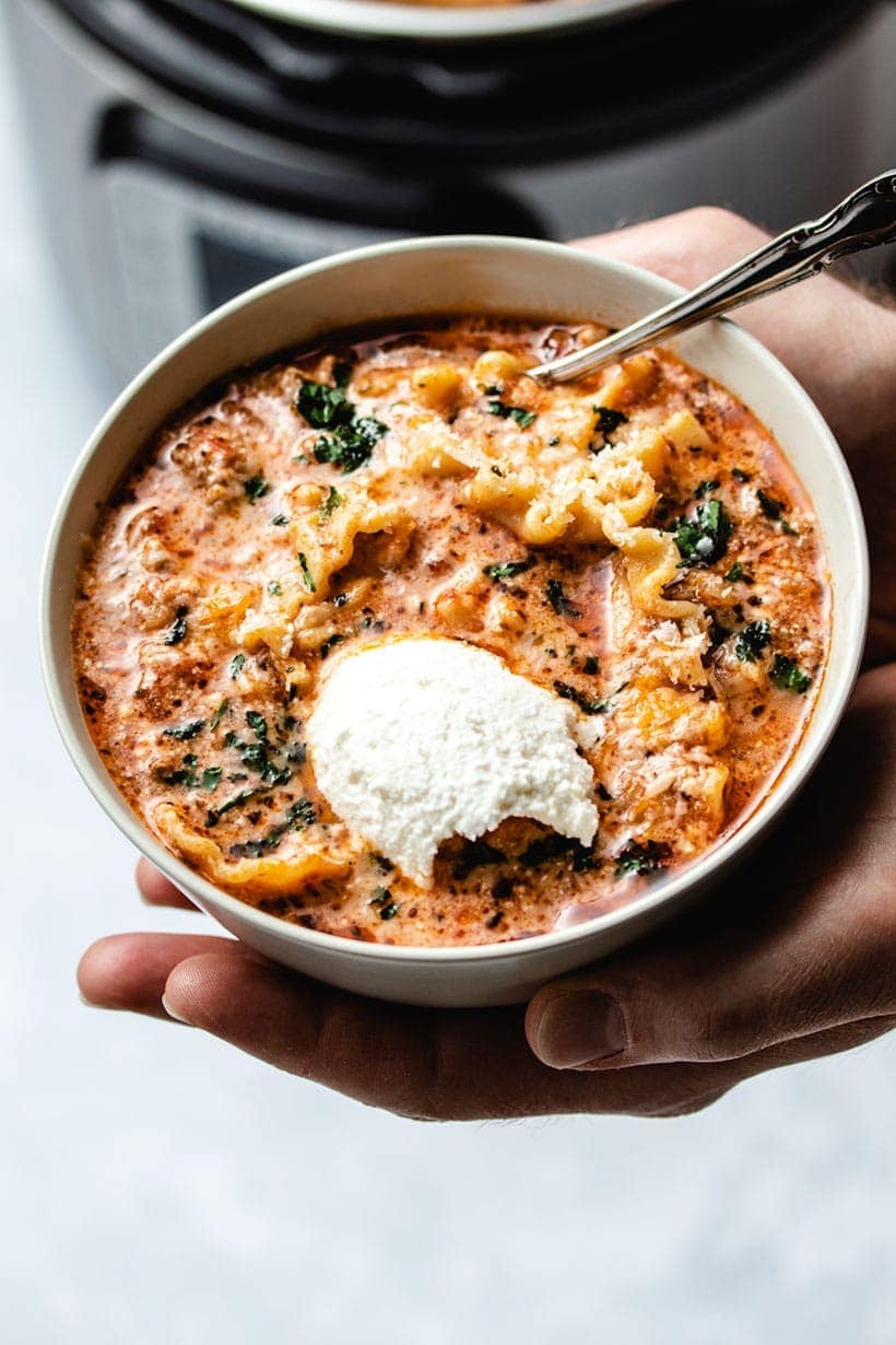 Bowl of homemade Instant Pot Lasagna Soup garnished with parsley and grated parmesan 