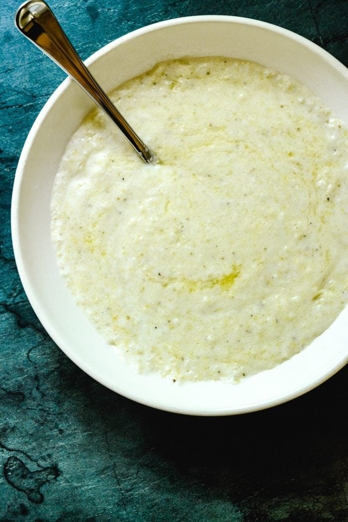 Bowl with creamy grits with garlic shrimps and cheese. 