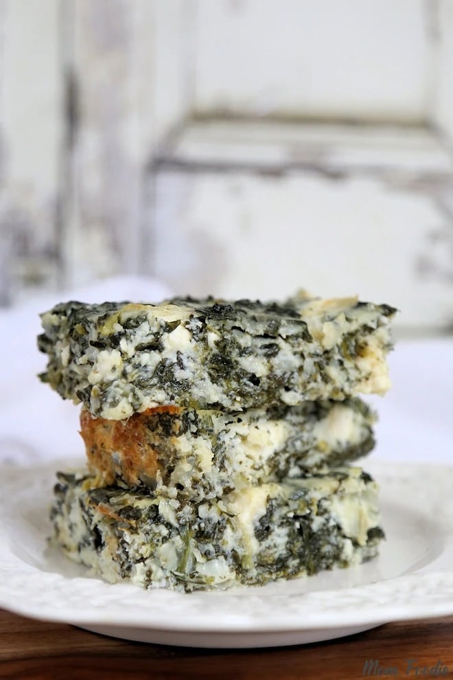 Stack of Cottage Cheese Casserole slices made with spinach, egg whites and cheese, served on a plate