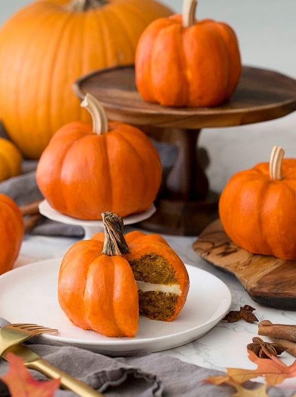 Mini pumpkin cakes on a marble table. 