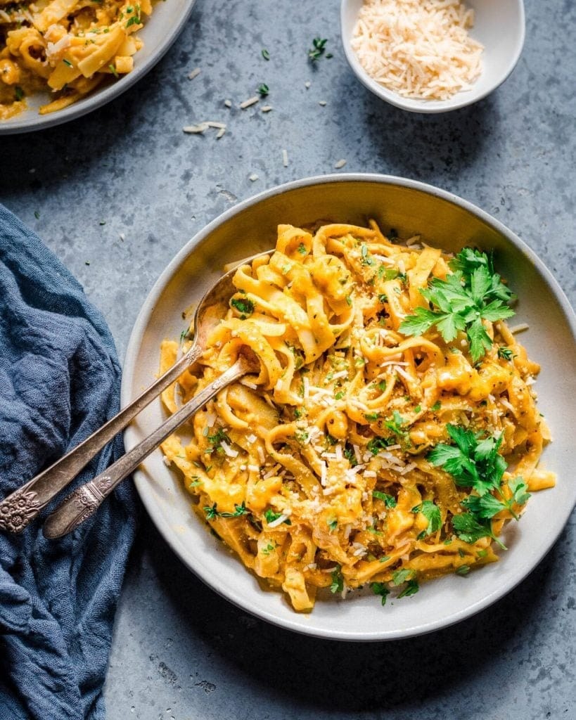 Pumpkin pasta served on a plate with parmesan cheese. 