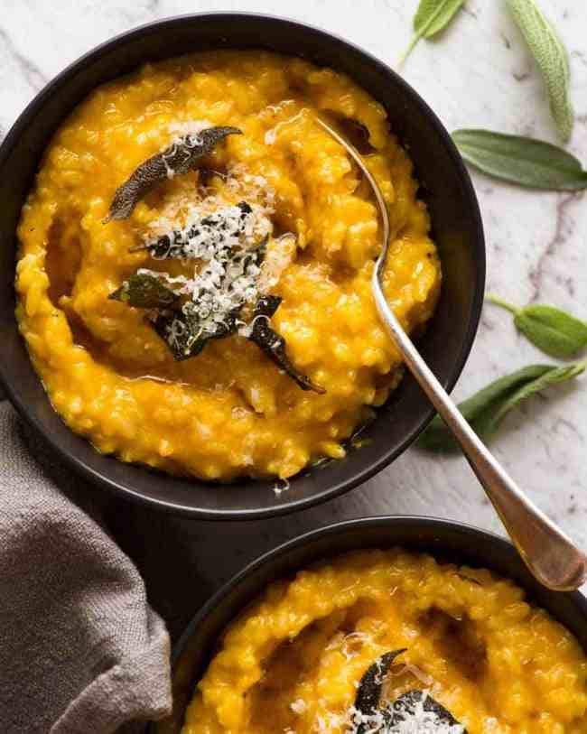 Pumpkin risotto served on black bowls. 