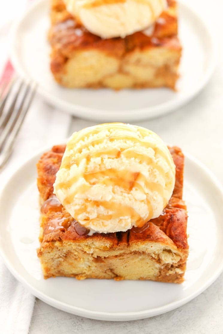 Slice of pumpkin bread pudding with scoop of vanilla ice cream on top. 