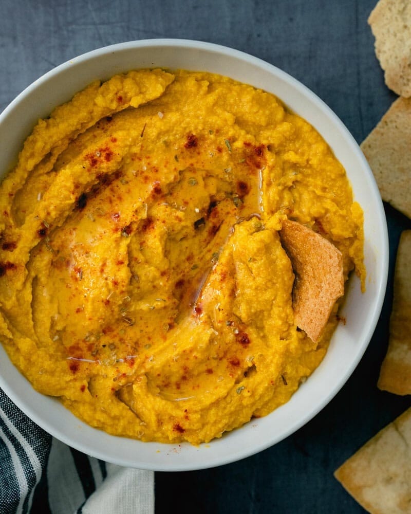 Top view of a bowl of pumpkin hummus. 