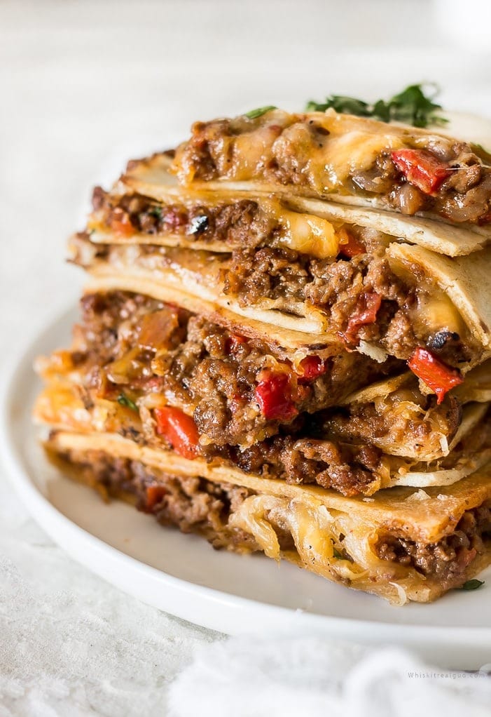 Sliced quesadilla on a plate cooked in a sheet pan.