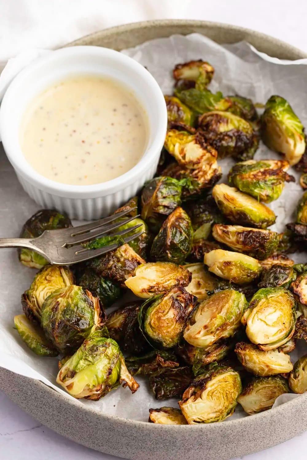 Plater of Roasted Brussels Sprouts with bowl of dipping sauce