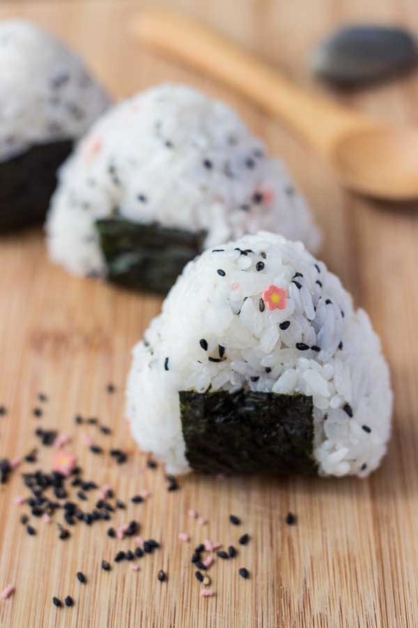 Onigiri rice ball on a wooden board. 