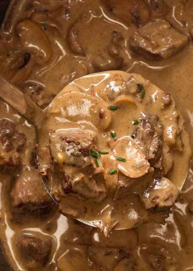 Ladle scooping Slow cooker beef stroganoff stew.