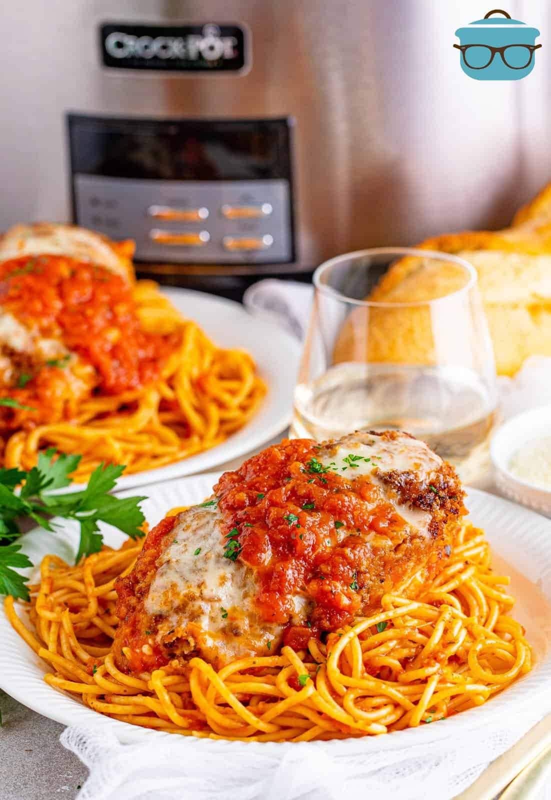 Slow Cooker Chicken Parmesan garnished with chopped parsley