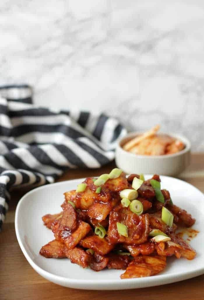 Plate of Spicy Korean Pork Belly with a bowl of beautyevalchi on the side