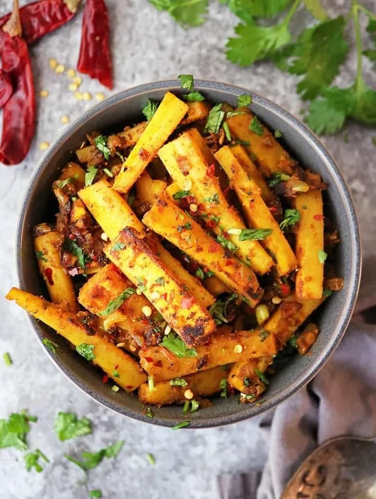 Golden pan roasted parsnips in a bowl.