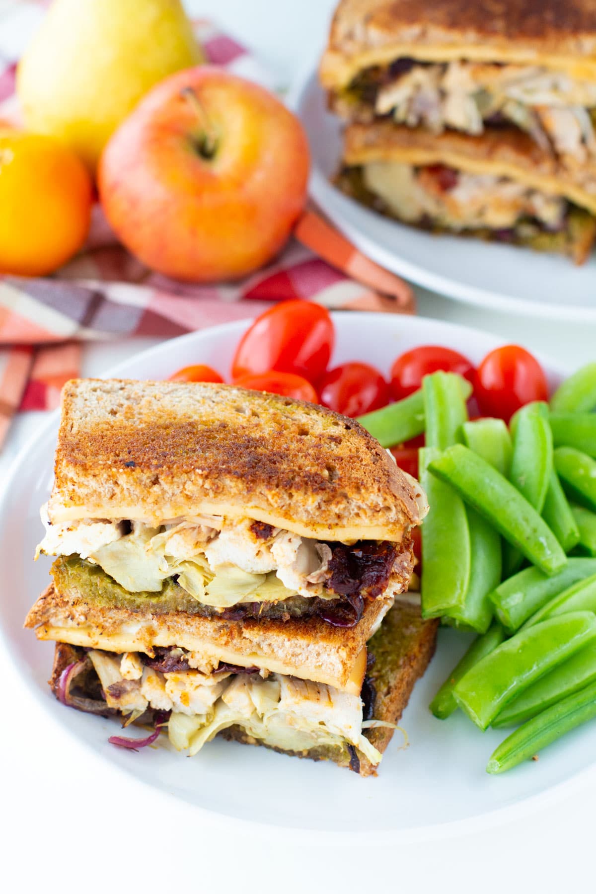 Leftover turkey sandwich served with string beans and cherry tomatoes on sides. 