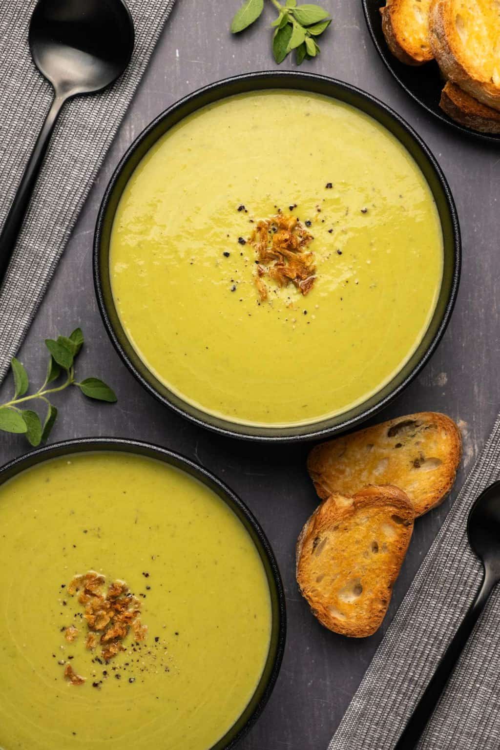 Vegan Asparagus Soup in a Black Bowl Served with Bread