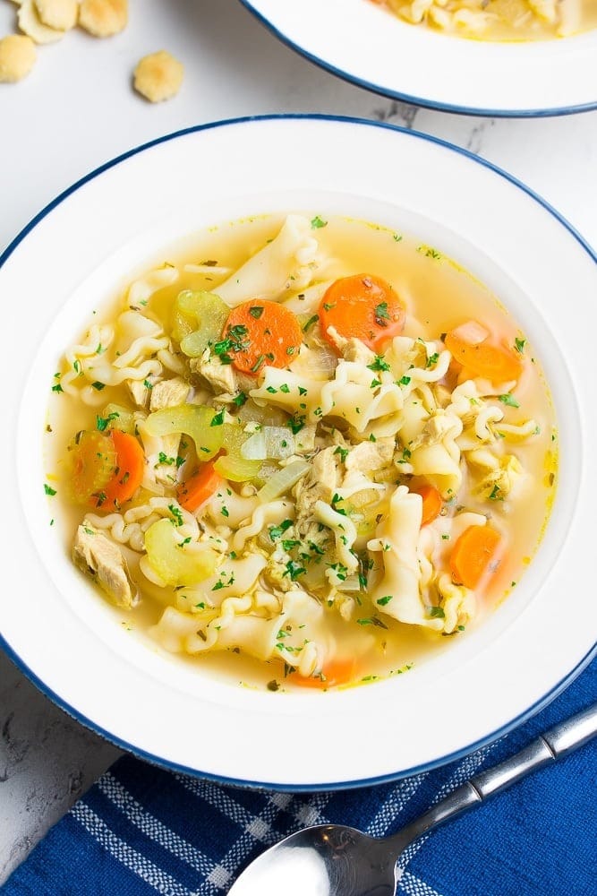 Homemade Vegan Chicken Noodle Soup with carrots, celery stalks and garnished with parsley