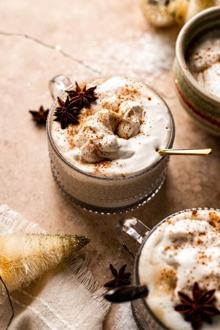 Homemade eggnog with a sprinkle of cinnamon and a touch of star anise.