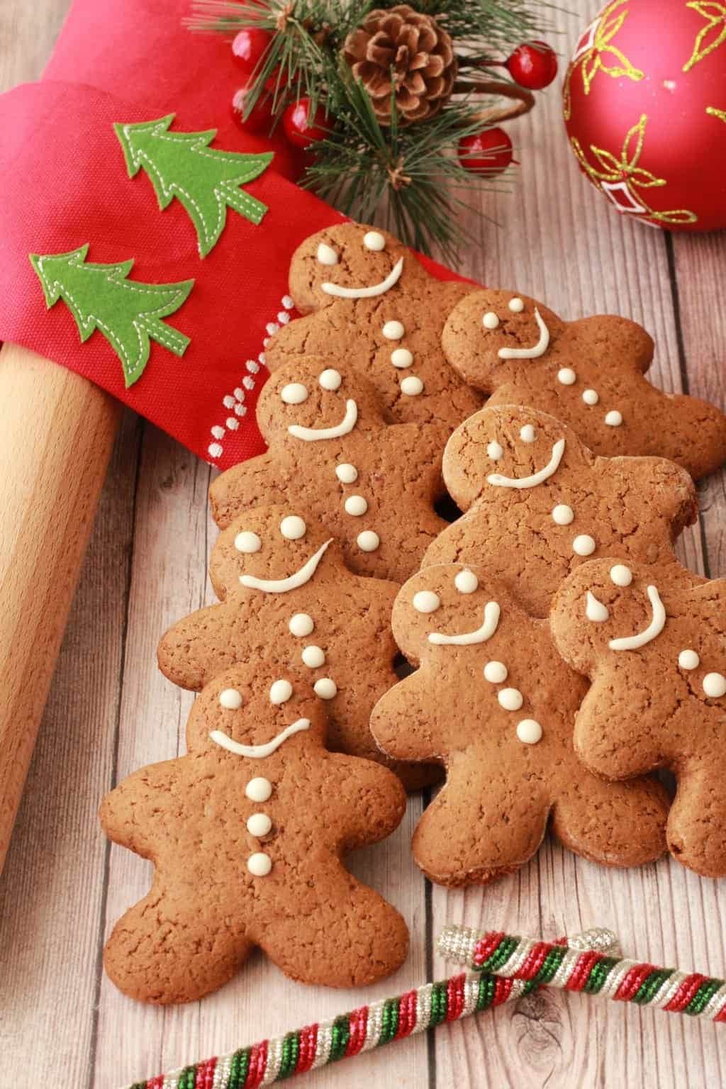 Bunch of gingerbread cookies on a decorated holiday table.