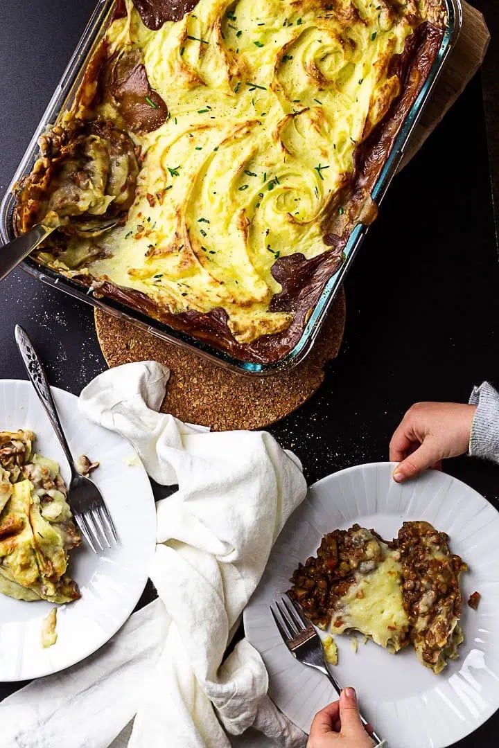 Vegan shepherd's pie on a casserole, served on plate.