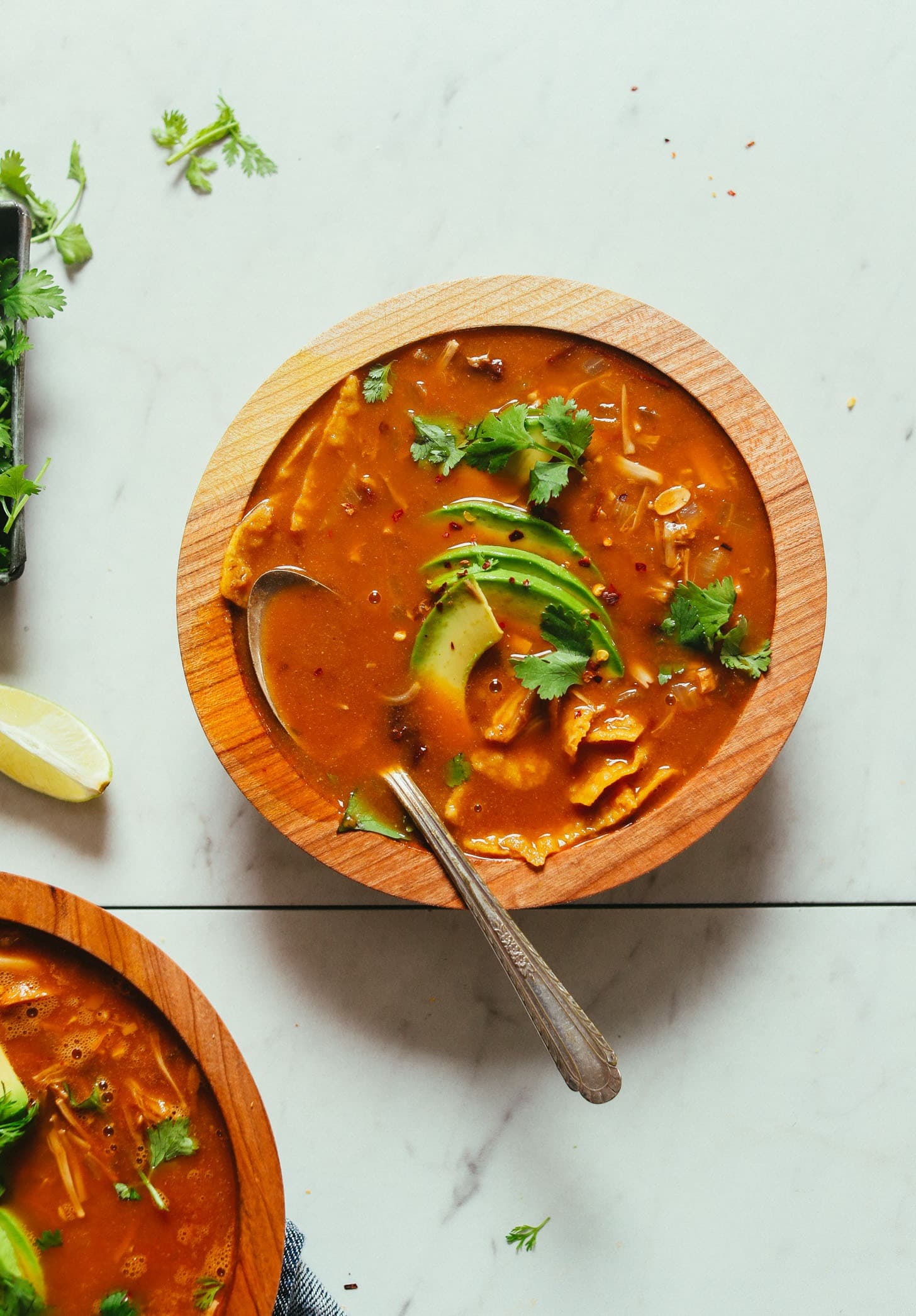 Bowl of homemade Vegan Tortilla Soup with slice avocados and garnished with cilantro