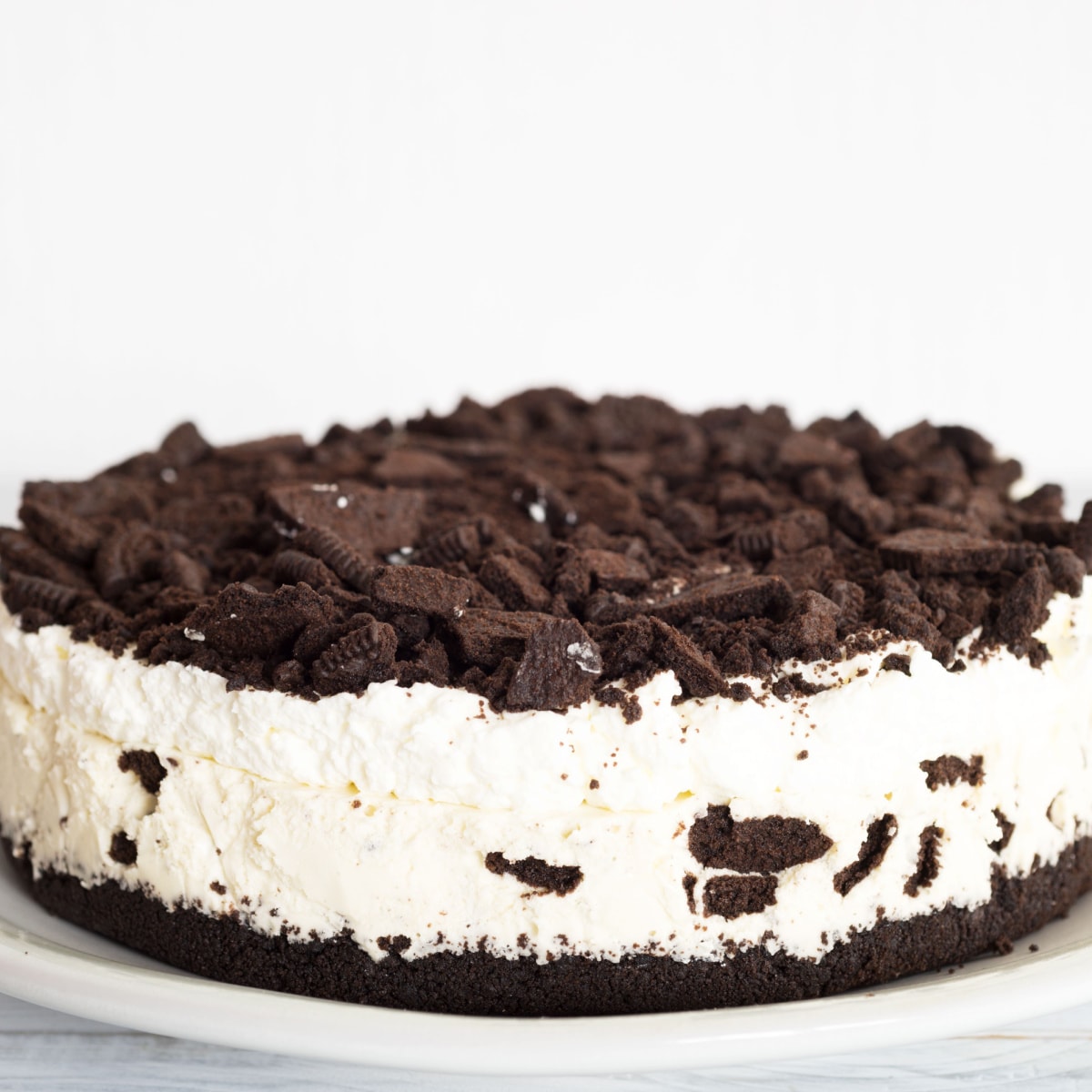 Whole No-Bake Oreo Cheesecake on a plate. 