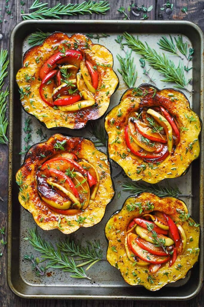 Roasted acorn squash halves stuffed with sliced apples. 