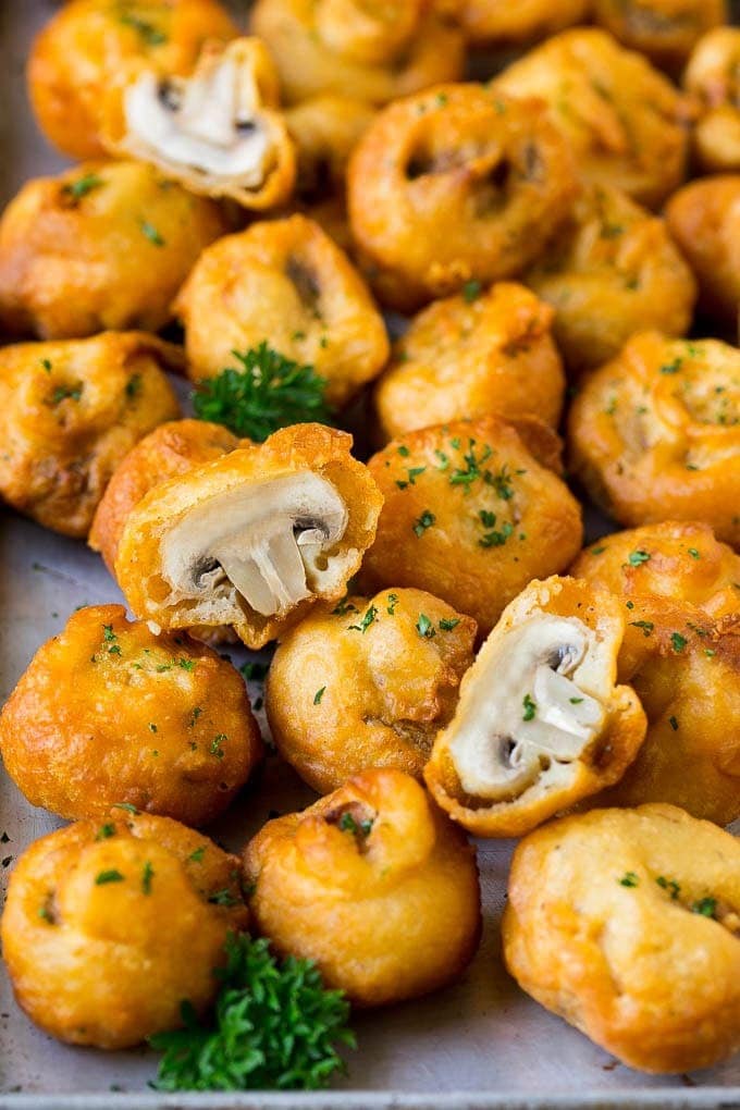 Batter covered fried mushroom on sheet pan. 