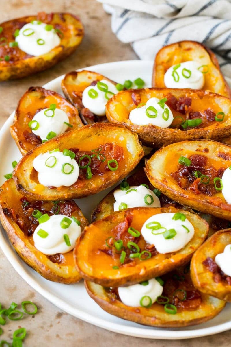 Russet potato halves loaded with cheese and bacon, baked until fluffy and tender, and topped with sour cream and scallions.