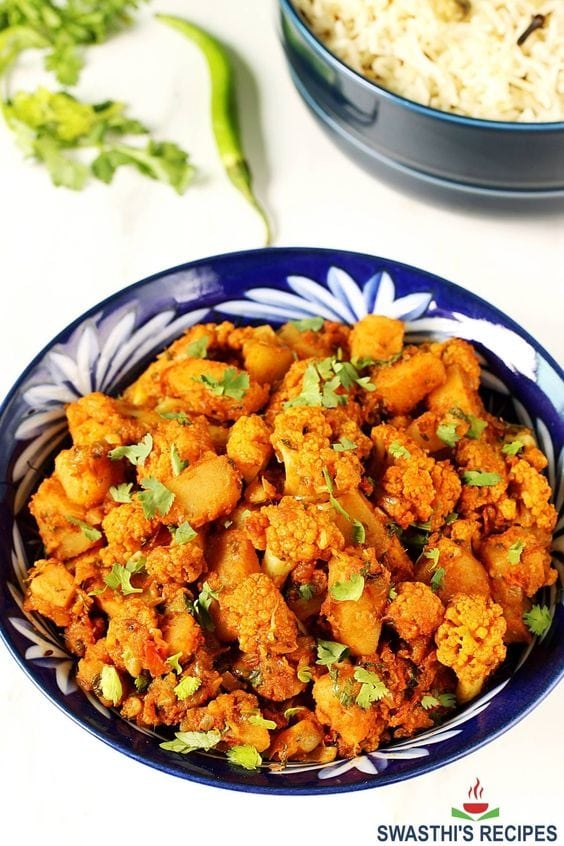 Bowl of aloo gobi made with seasoned potato and cauliflower.