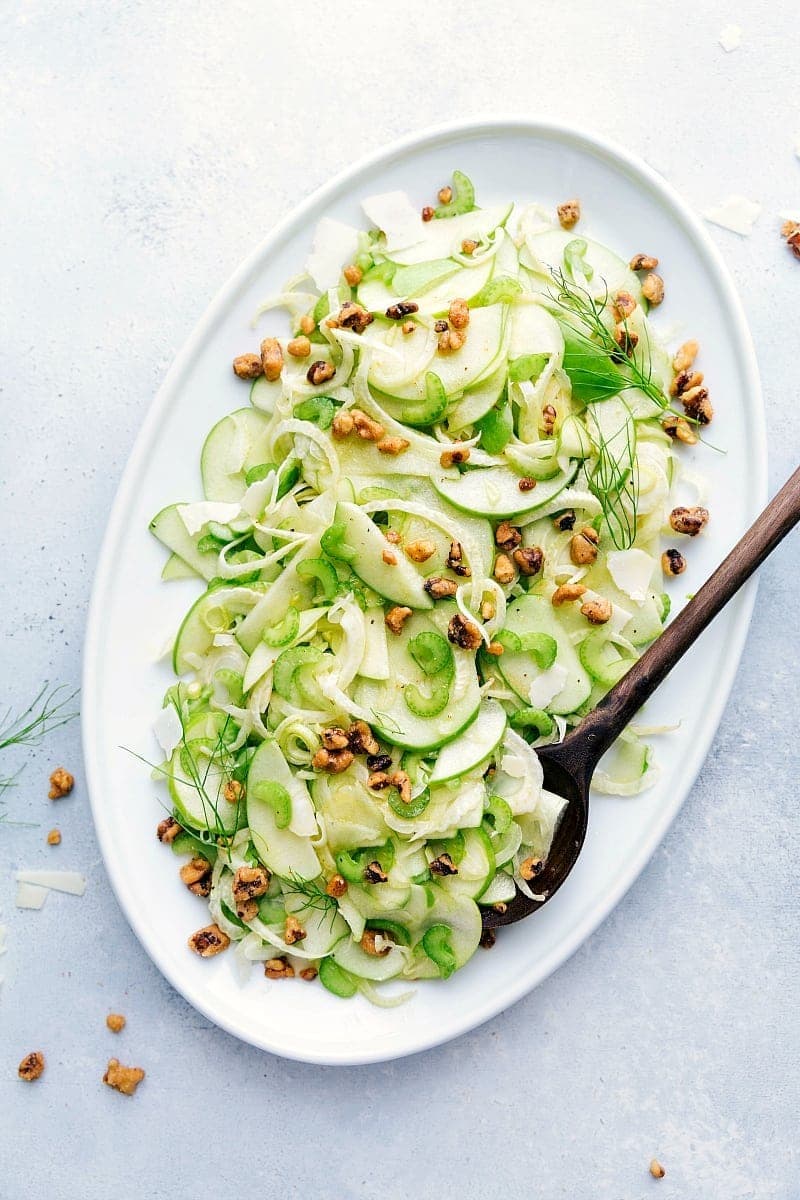 Sliced apple salad with chopped walnuts and fennel. 