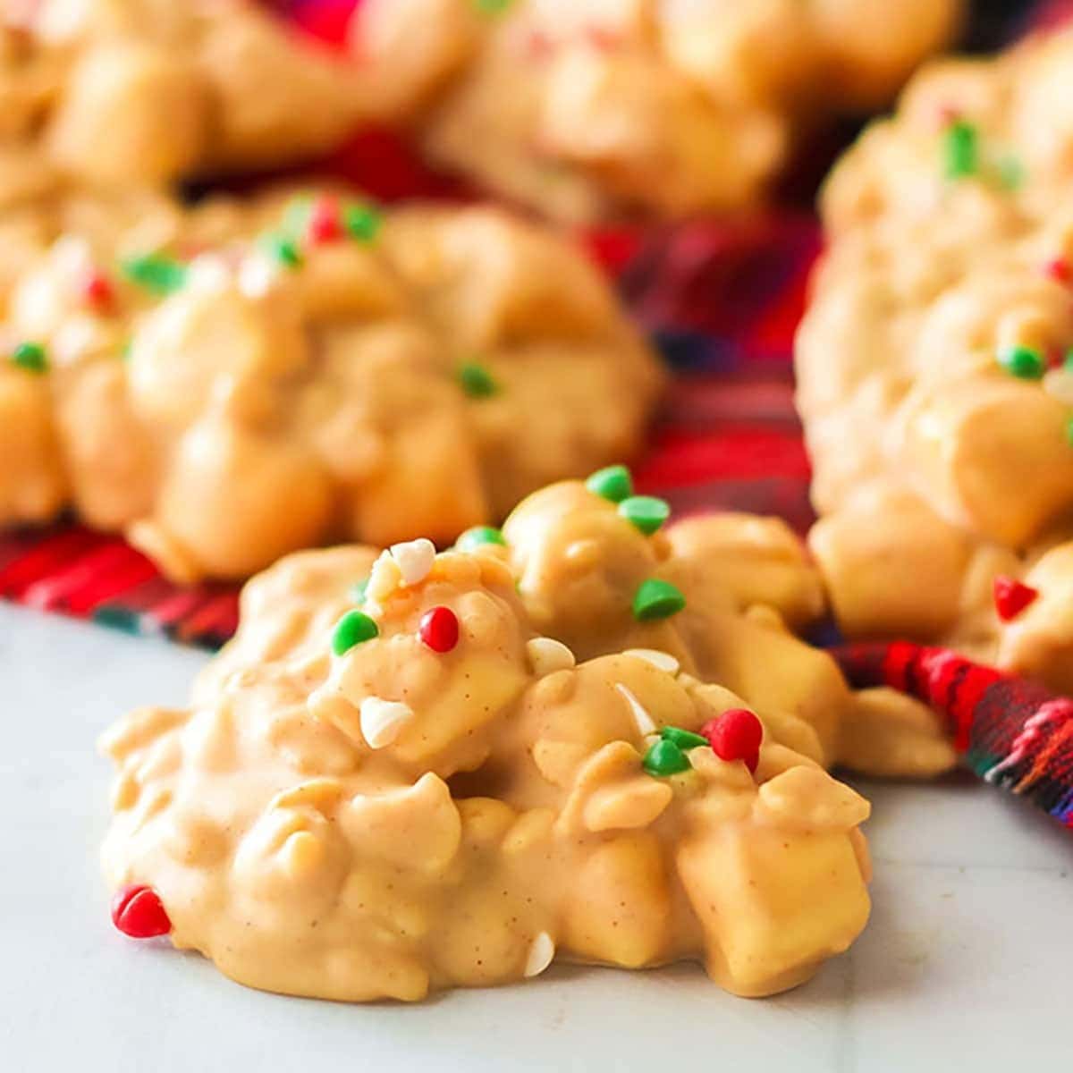 Bunch of peanut butter cream covered avalanche cookies M&Ms garnish on top.