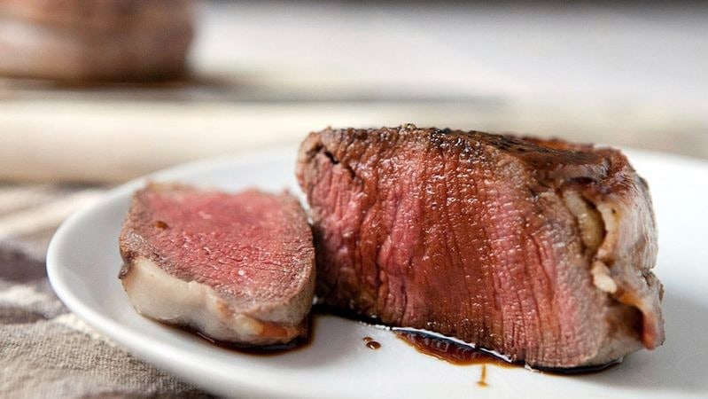 Bacon-wrapped filet mignon in a plate. 