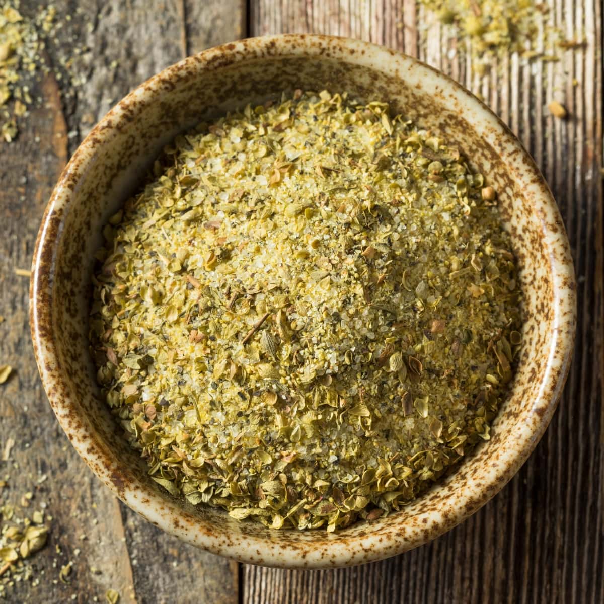 Bowl of Adobo Seasoning on a Wooden Board