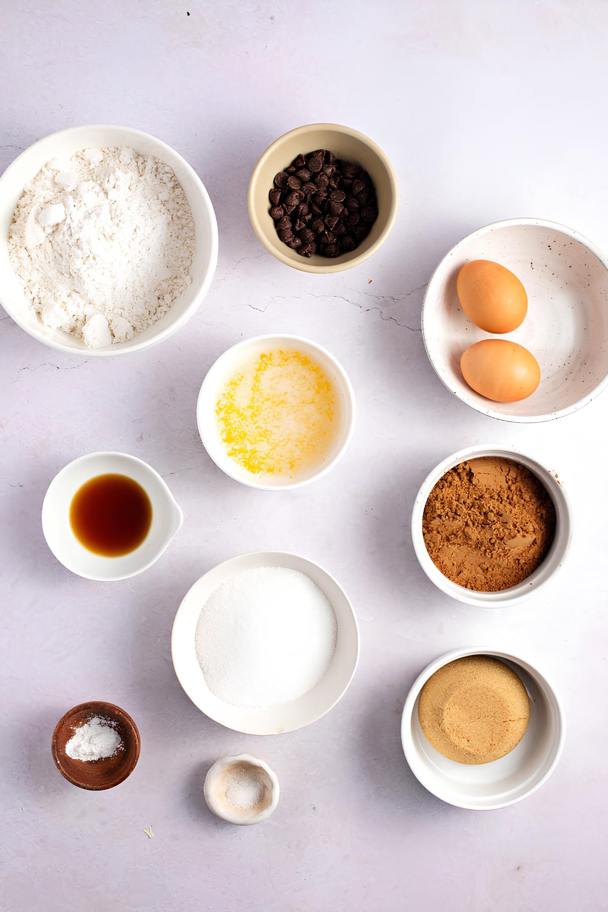 Brownie cookie ingredients: unsalted butter, melted, Dutch cocoa powder, white sugar, brown sugar, one large egg, vanilla extract, all-purpose flour, baking powder, pinch of salt, semisweet chocolate chips.