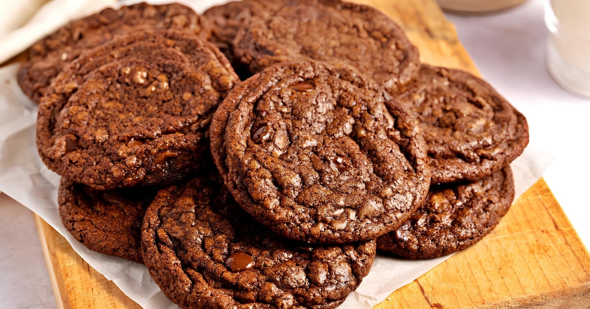 Bunch of chocolatey cookie brownies on a wooden board.