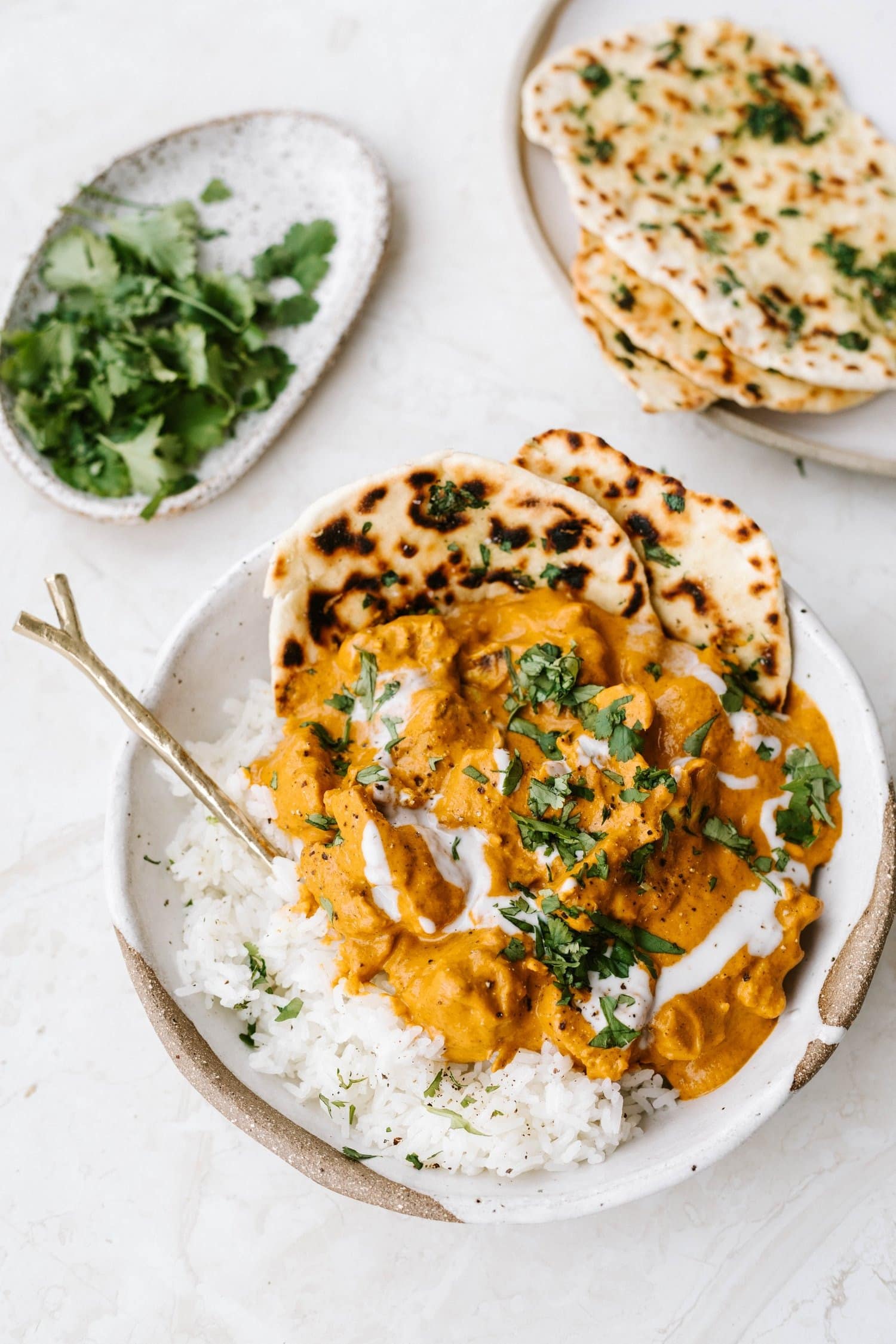 Jackfruit curry served on top of white rice with pita bread.