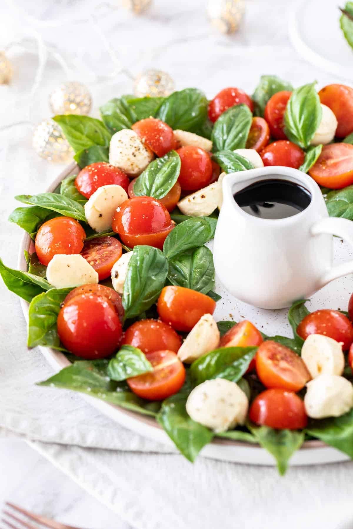 Salad with tomatoes, basil, fresh mozzarella and olive dressing. 