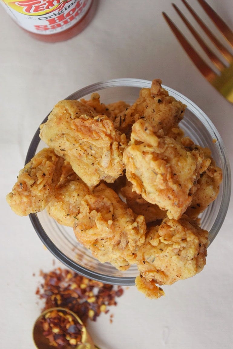 Breaded jackfruit bites in a glass bowl.