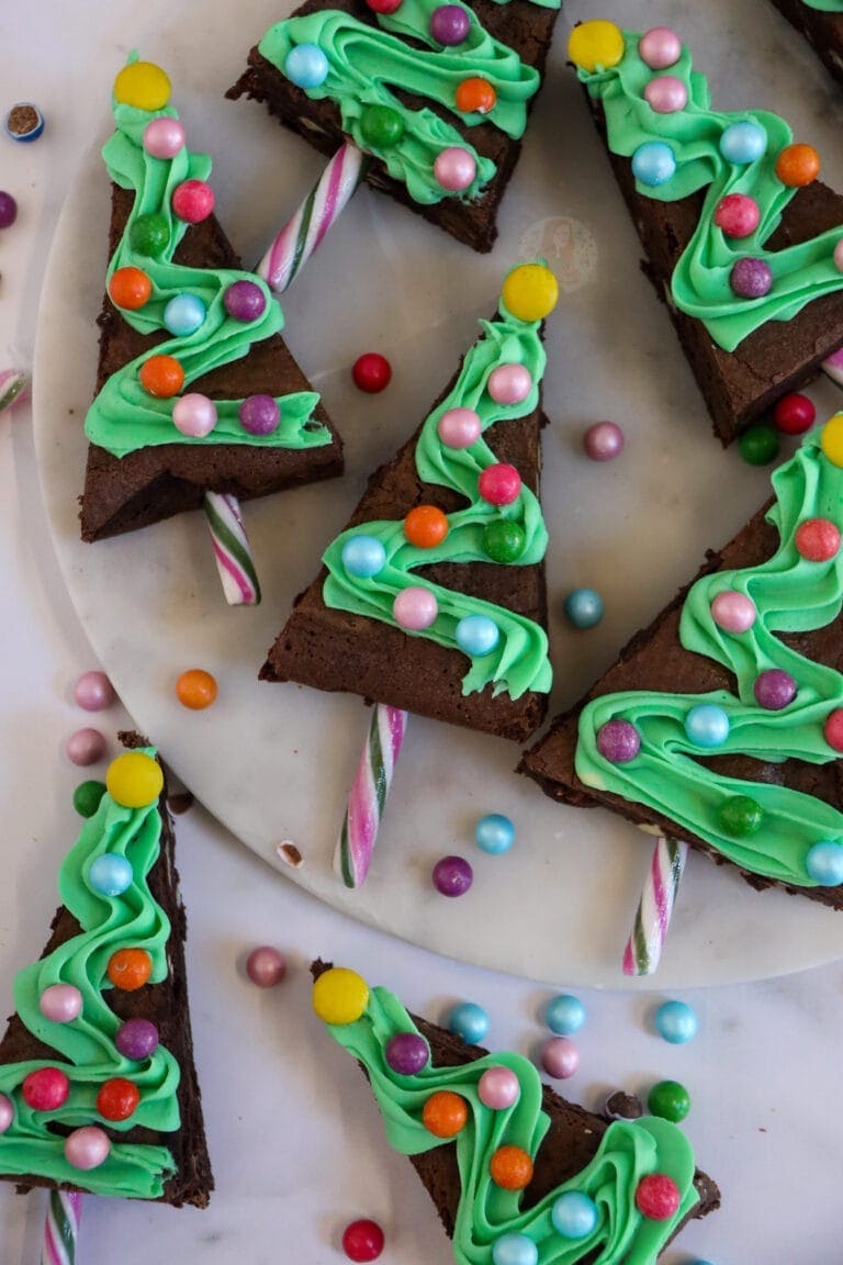 Christmas tree shaped brownies decorated with  green frosting and candies.