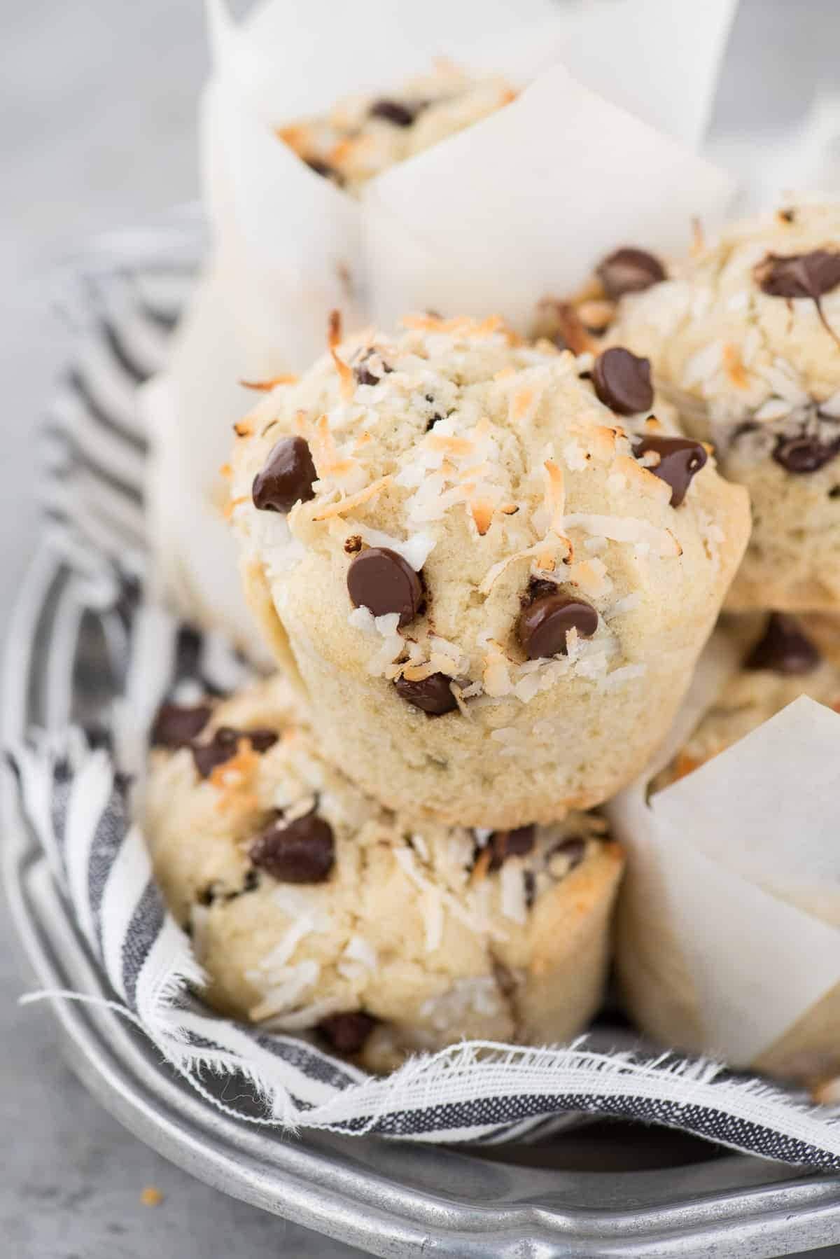 Chocolate muffins with shredded coconut stack on a plate. 