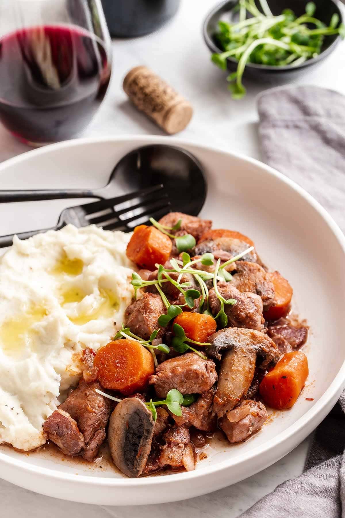 Serving of mushroom stew cooked with veggies, chicken and sauce served with mashed potatoes. 