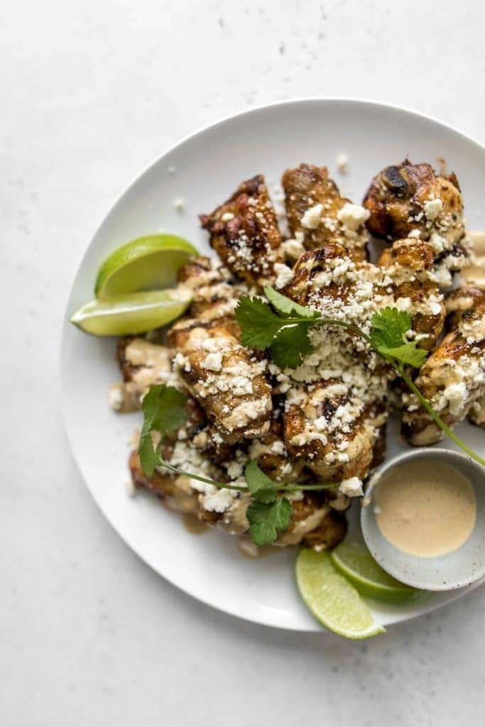 Fried chicken wings sprinkled with parmesan cheese. 