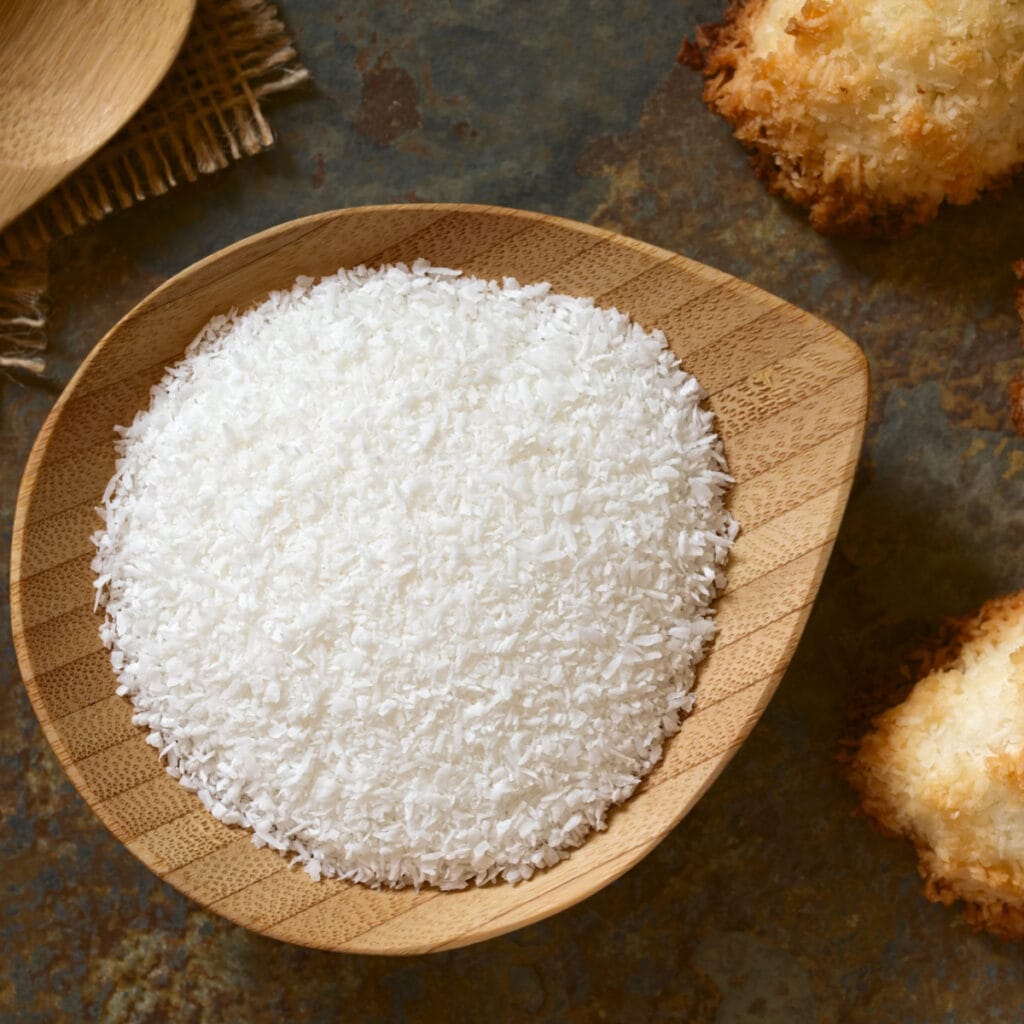 Shredded coconut on a wooden bowl.