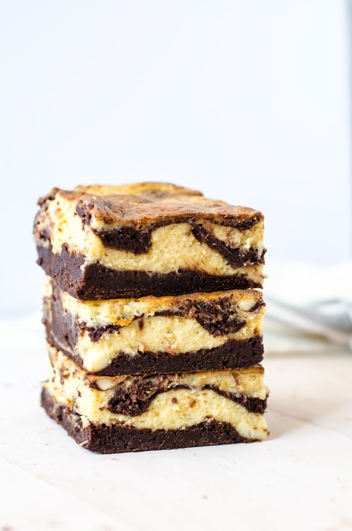 A stack of eggnog cheesecake brownie bars.