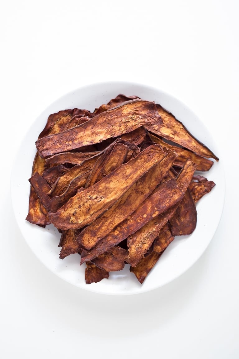 Fried thin strips of eggplant in a white bowl. 